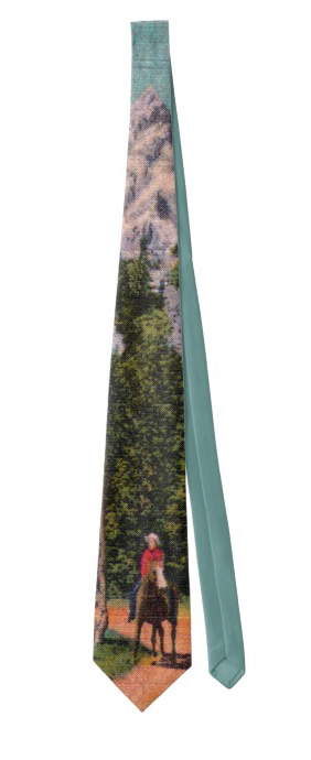 Neck tie with an old fashioned image of cowboy on a horse in front of big mountains.